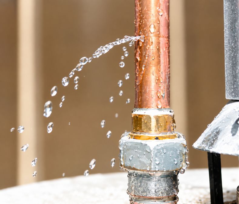 Burst copper pipe leaking water, a common Leesburg plumbing emergency