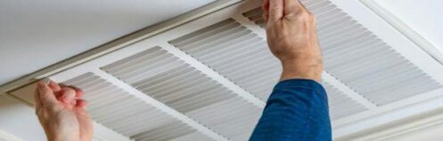 HVAC technician inspecting residential ductwork for professional duct cleaning in Clermont FL