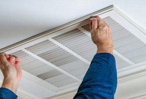 HVAC technician inspecting residential ductwork for professional duct cleaning in Clermont FL