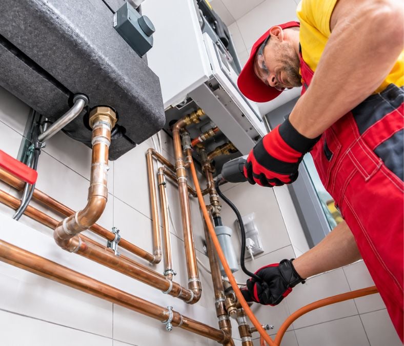 Heating service technician performing furnace maintenance