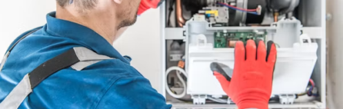 Heating technician inspecting a home heating system