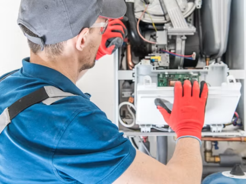 Heating technician inspecting a home heating system